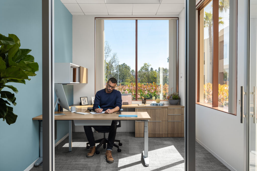 Man working at desk inside an office at Eastgate in San Diego.